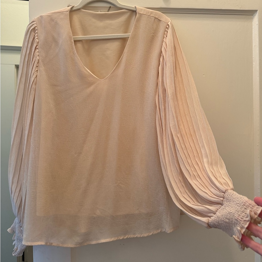 Cream Women’s blouse with ruffle sleeves